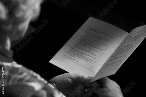 old lady with a prayer book in her hands