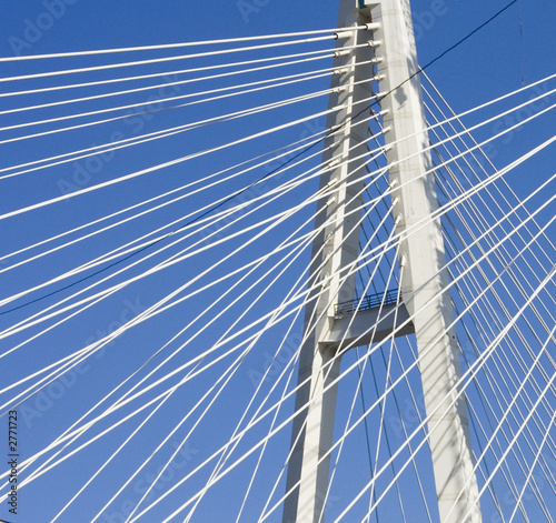 suspension bridge cables in blue sky 
