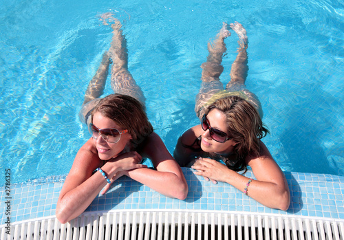 two girlfriends enjoying the sun whilst on vacatio photo