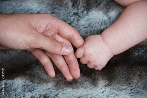 baby hand holding daddy's hand