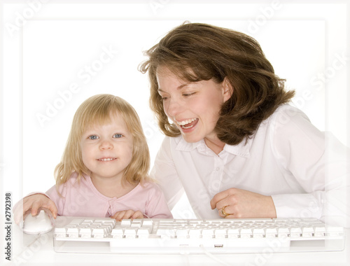 daughter showing mom something on computer laughin photo