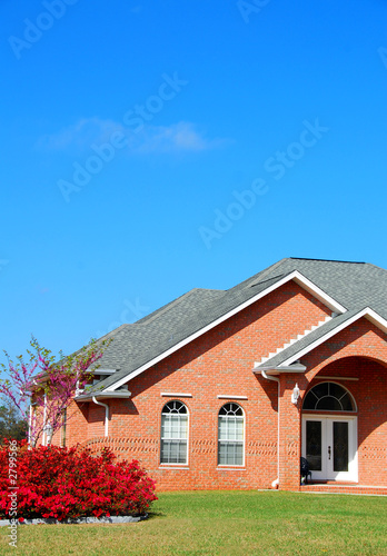 brick home with landscaping