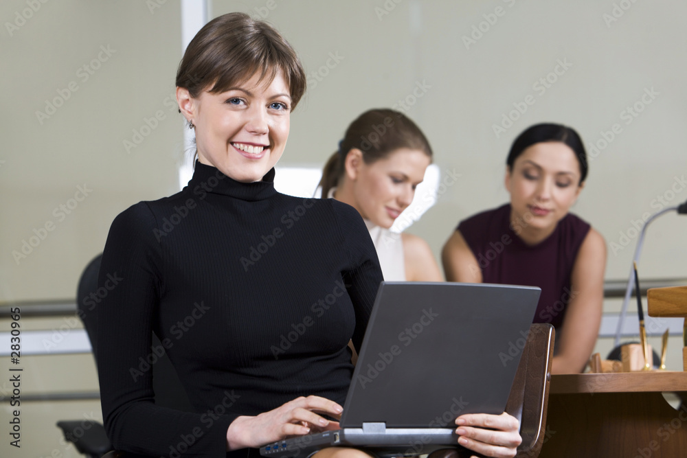 portrait of smiling woman with the laptop on her k portrait of smiling woman with the laptop on her k