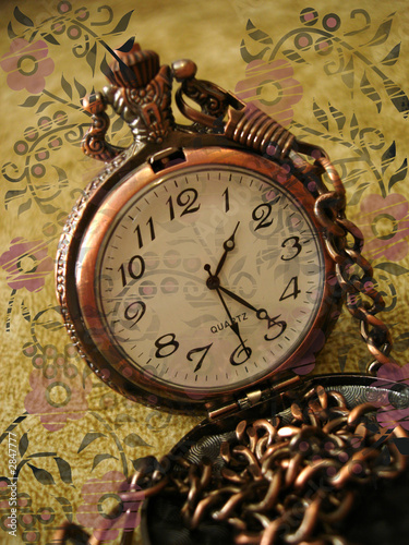 old clock on vintage background with flowers