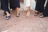 bride and bridemaids with flip flops