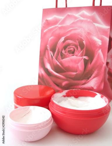 many containers of cosmetic moisturizing cream and bag over whit