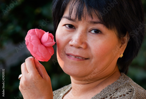 asian woman holding a flower