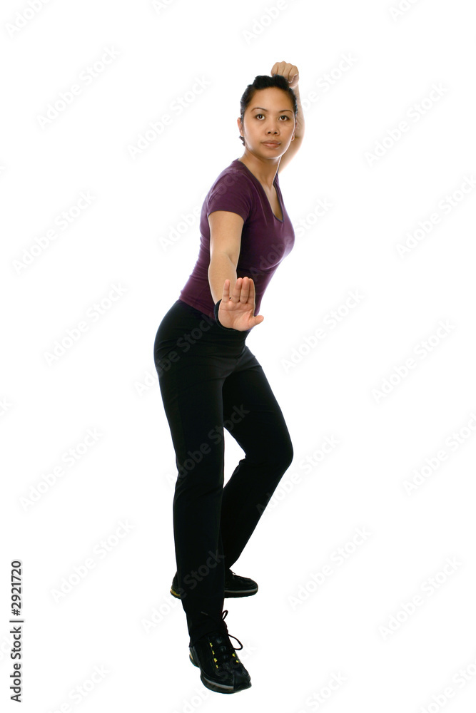 Obraz premium Asian woman in combat taichi stance, shot against white.
