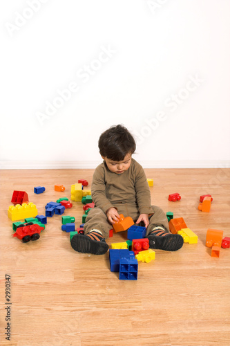 baby playing on laminated flooring