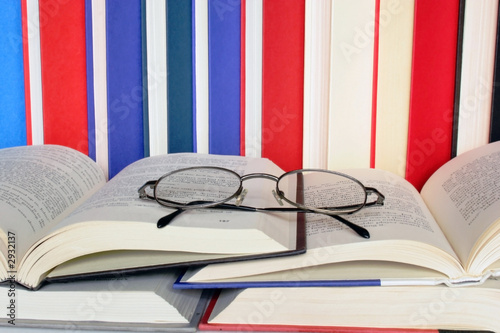 eyeglasses on open books
