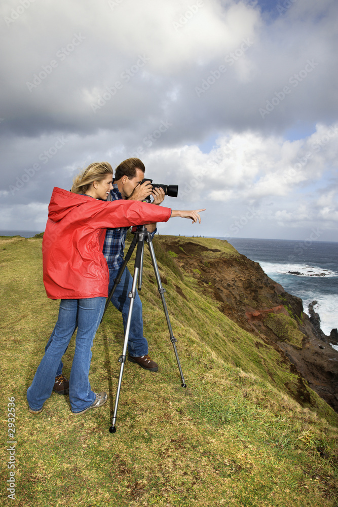 couple photographing scenery in maui, hawaii.