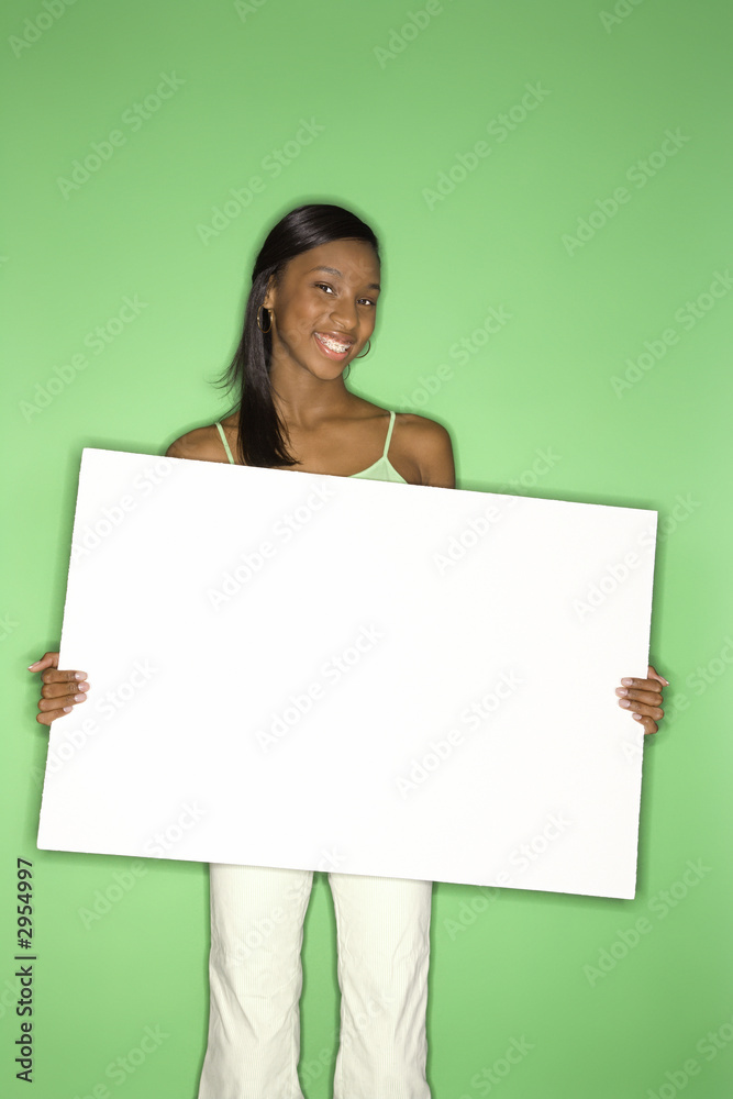 african-american teen girl holding blank white board. african-american teen girl holding blank white board.