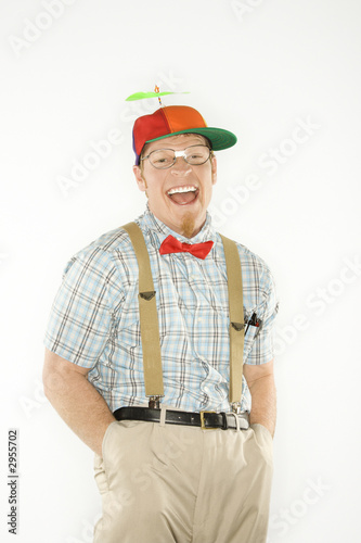young man dressed like nerd with hands in pockets.