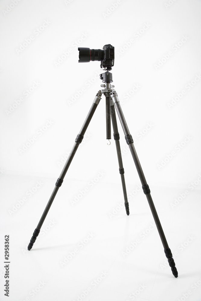 studio shot of camera and tripod. studio shot of camera and tripod.