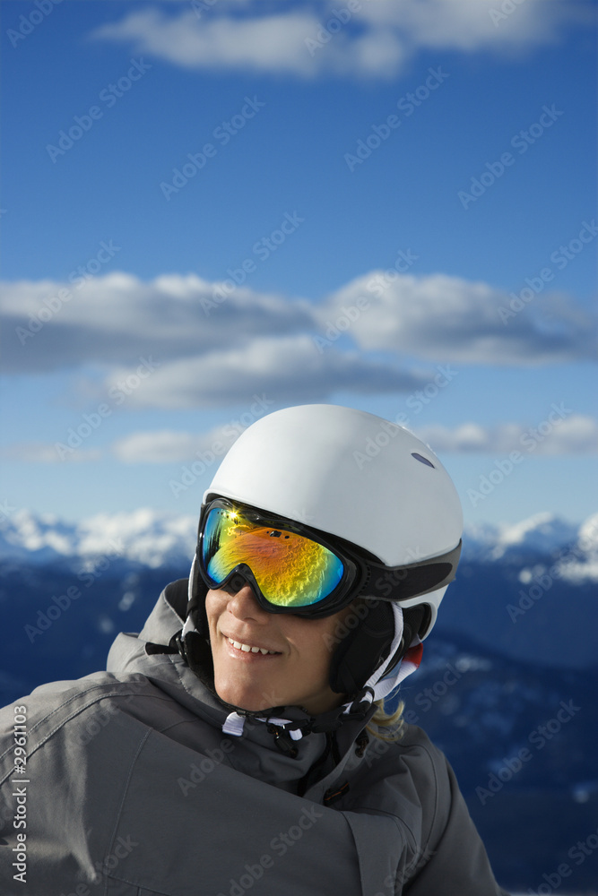 Teenage boy snowboarder in mountains.