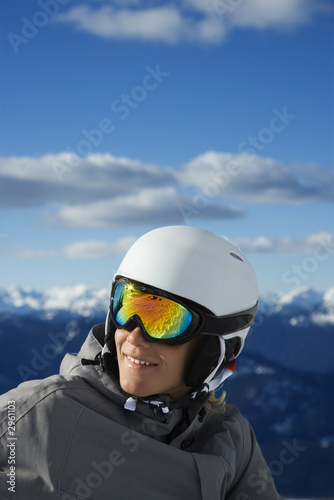 Teenage boy snowboarder in mountains.