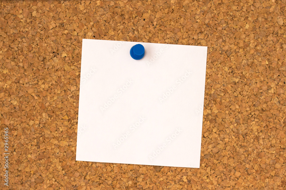 white note pinned to cork board white note pinned to cork board