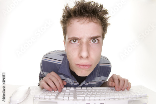 upset teenage boy at computer
