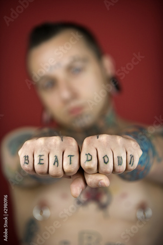 Adult male holding out fists reading beat down.