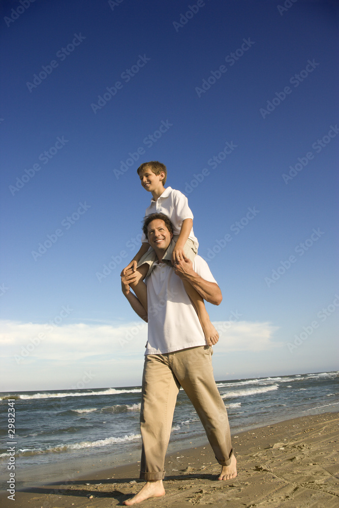Dad carrying son on his shoulders. Dad carrying son on his shoulders.