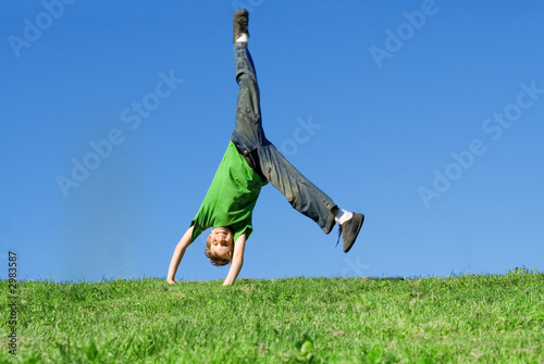 happy child playing, cartwheel photo