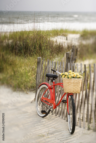 Bike leaning against fence at beach. #2984928