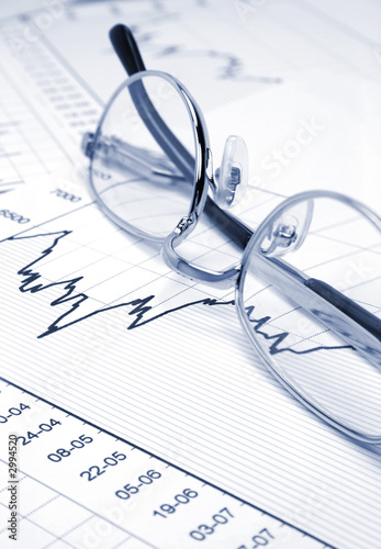 stock chart and eyeglasses