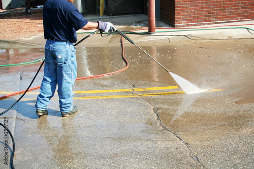 a crew member cleans the painted street markings