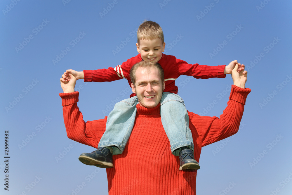 father with son on shoulders father with son on shoulders