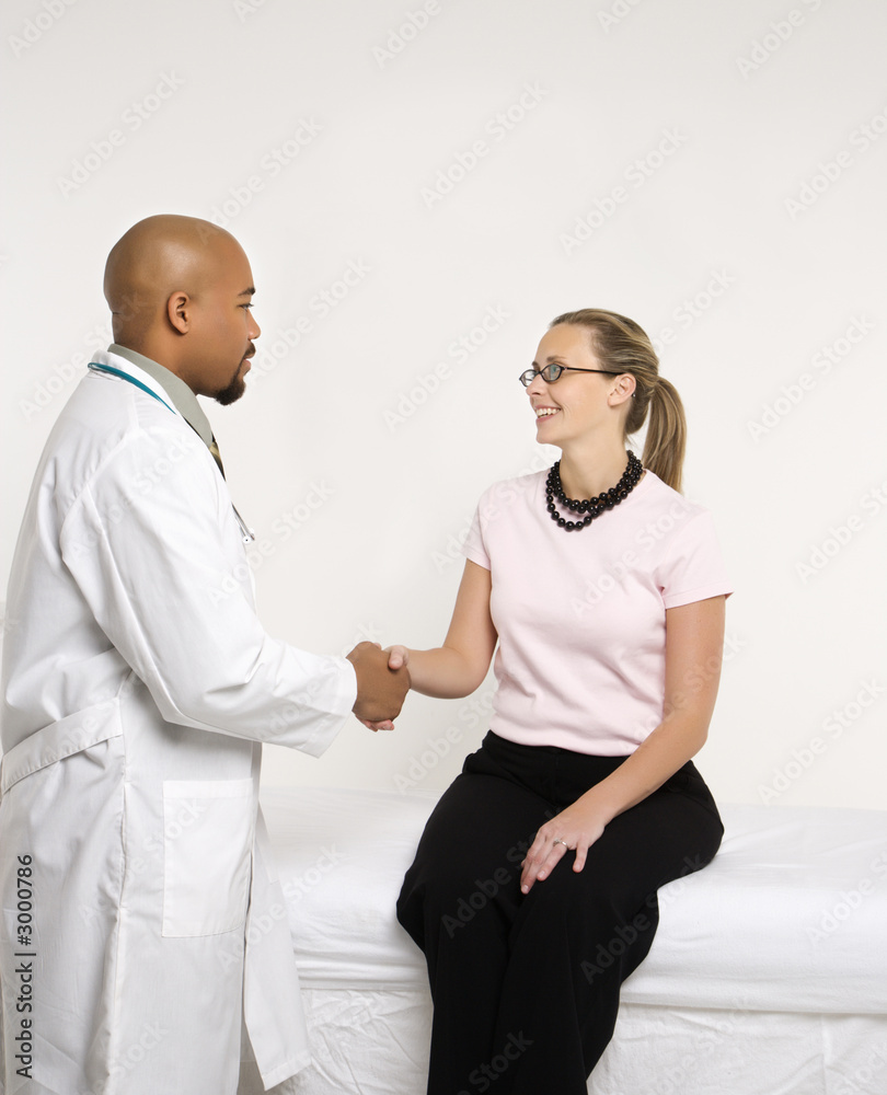 doctor and patient shaking hands.