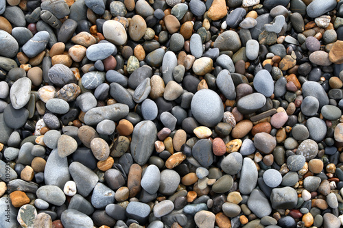 Tela close up of colorful stones on a beach.