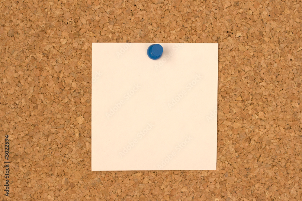 white note pinned to cork board