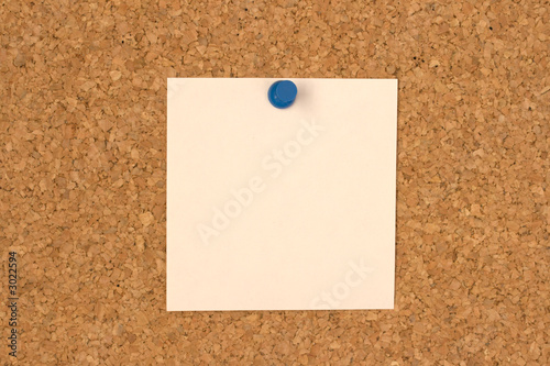 white note pinned to cork board