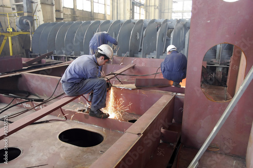 Photography A worker is welding steel