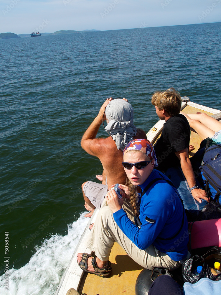 group of tourists on motorboat