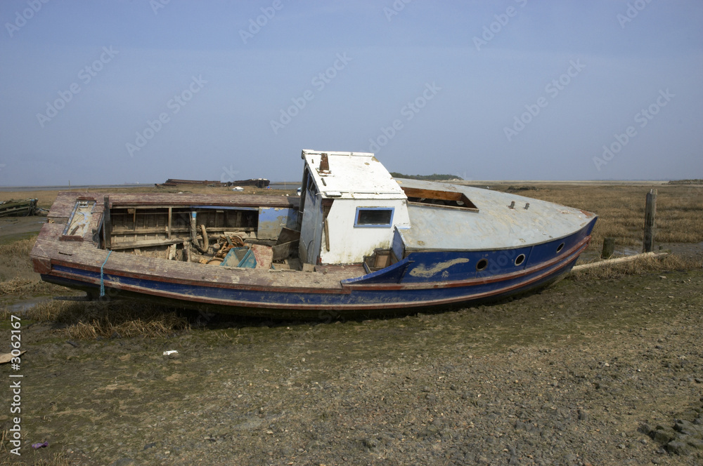 small boat in the mud