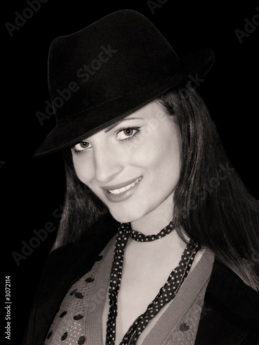 portrait of the smiling girl in a black hat
