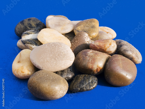 wet stones on blue background