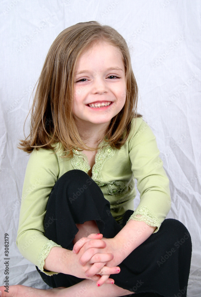 cute little girl sitting on a white background cute little girl sitting on a white background