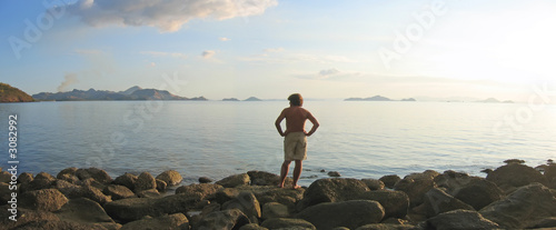 Fényképezés a man looking over the infinite tropical sea and island archipel