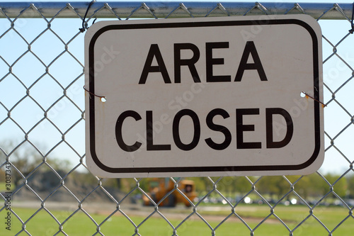 "area closed" sign in front of a building site