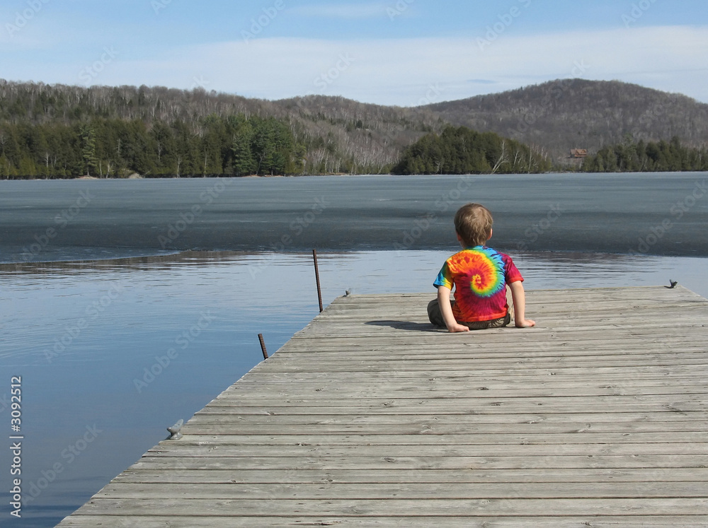 little boy at lake in spring