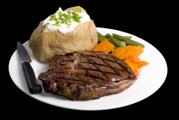 Fototapete Steakhouse Ribeye Steak auf dunklem Untergrund  © Thomas Perkins