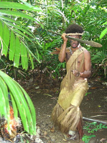 melanesian in native traditional dress with spear photo