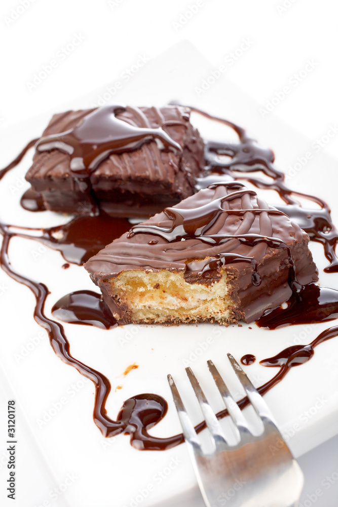 two chocolate cakes with syrup and the fork