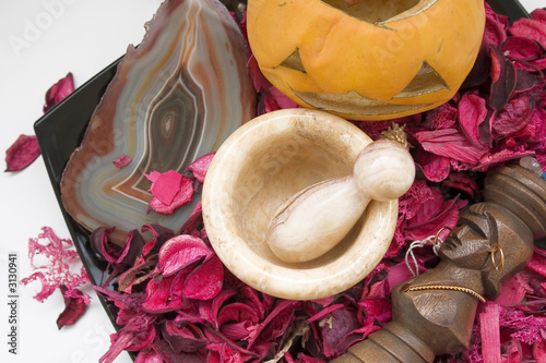 still life with red petals, pumpkin and other deco