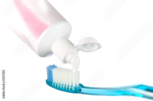 toothbrush and paste on white