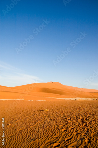 Red sand desert and blue sky