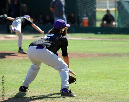 3rd baseman ready as pitch is delivered