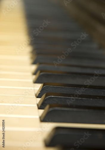 antique piano with yellowish old keyboard.